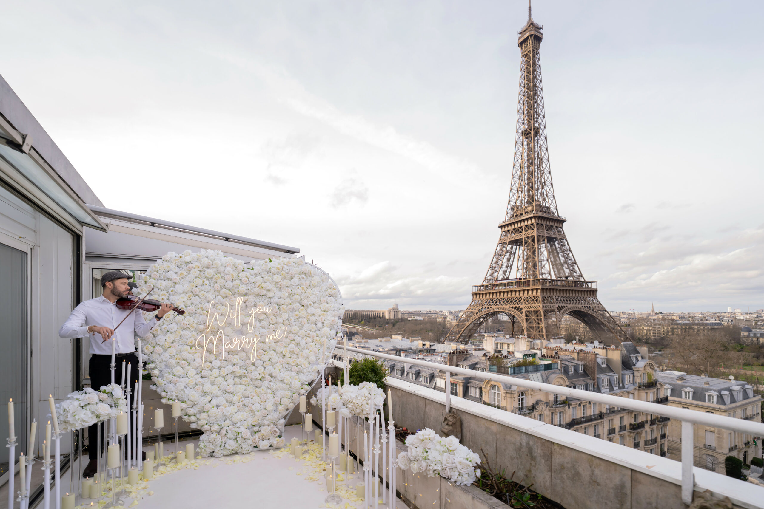 Terrace Eiffel by day with a big white heart of flowers and a violonist