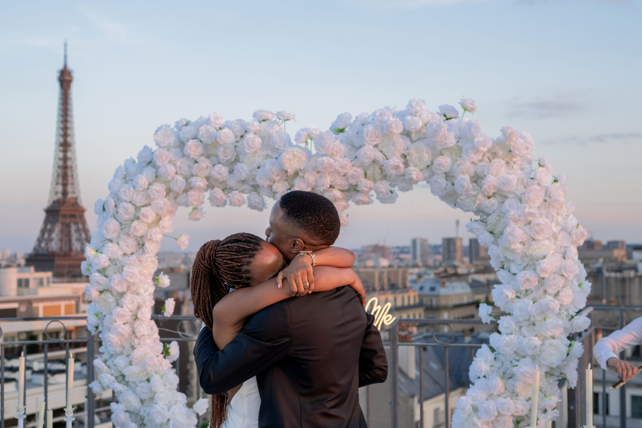 a happy women in arm of his new fiancé with the Eiffel Tower in back