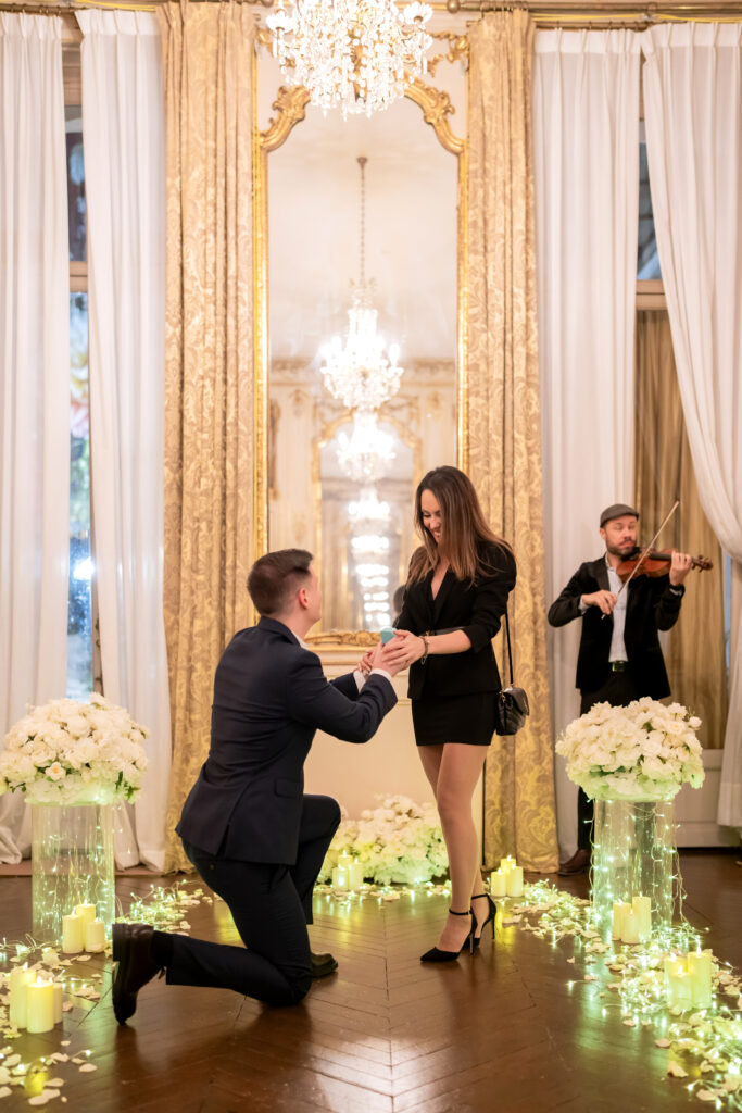 Live violinist performing, creating a romantic atmosphere for a proposal.