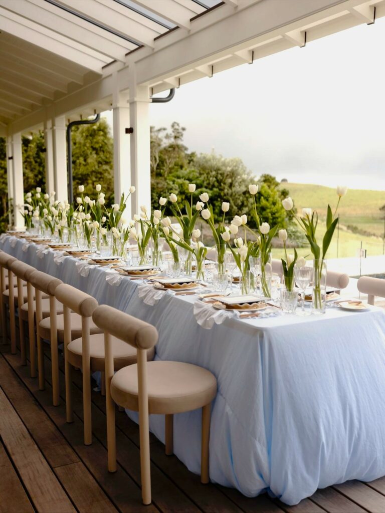 Tulips on a long table set for a ceremony