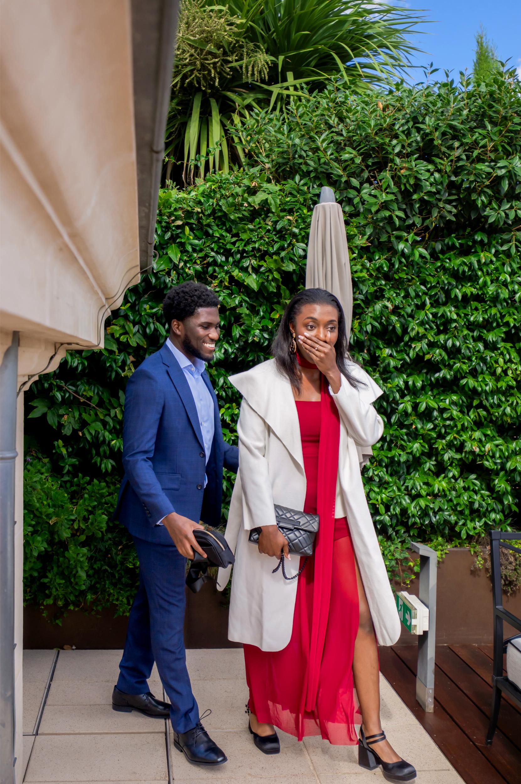 Couple surprised by a hidden proposal photographer at the Peninsula Paris terrace